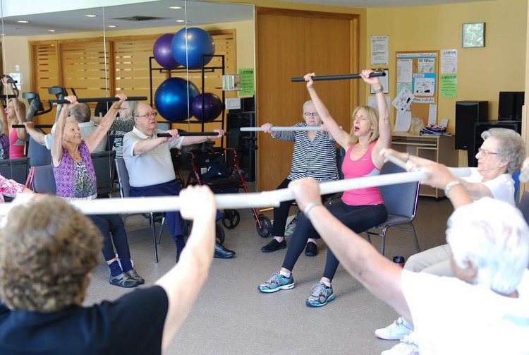 group of older adults in a seated fitness class
